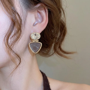 18k gold plated triangle drop earrings with crystals on a female model