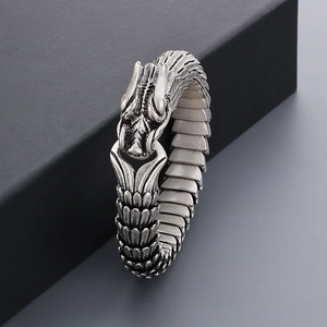 Macro view of vintage silver dragon scale bracelet with detailed dragon head clasp