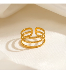 Detail eines 18K vergoldeten dreischichtigen verstellbaren Rings auf weißer Seide