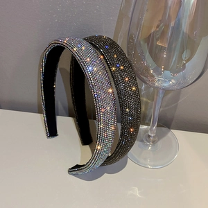 Detailed close-up of sparkling full-diamond headbands in silver and black colors