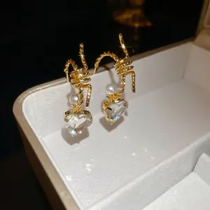 French vintage C-shaped pearl heart earrings with gold twisted texture design