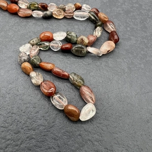 Macro shot of colorful irregular natural gemstone beads with smooth polished finish
