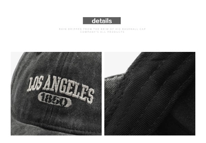 Detail of vintage washed black cotton baseball cap with white Los Angeles 1850 embroidery
