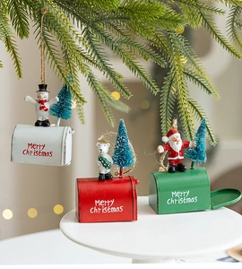 Detailed close-up of miniature Christmas mailboxes with resin figures on a tray