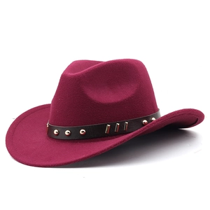 Detail of burgundy wool fedora with brown leather band and metallic gold studs