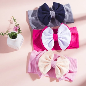 Detail of baby headbands with double bows and high-elasticity waffle knit texture