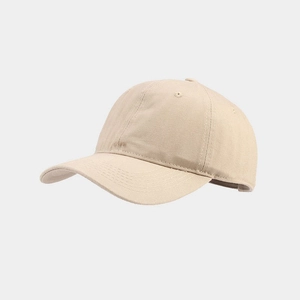 Detailed close-up of breathable cotton twill fabric and embroidery on beige baseball cap
