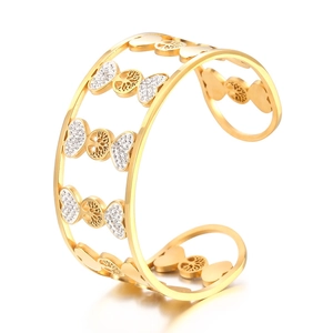 Golden cutout tree of life bangle with white crystals shown from a 45-degree angle