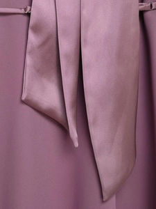 Detailed view of the purple satin neck tie with elegant silky texture and drape