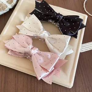 Three-piece satin polka dot bow hair claws in black, beige, and pink colors