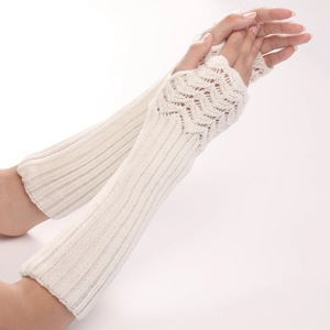 Close-up of cream knitted fingerless gloves showing detailed wave pattern and arm warmers