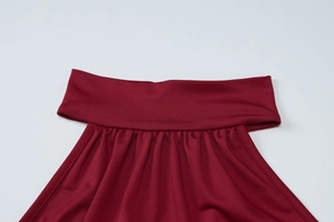 Detailed close-up of wine red halter dress showing pleated texture and knit fabric