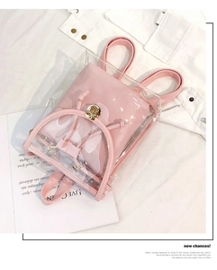Close-up of clear PVC backpack with pink inner pouch and metallic gold twist lock