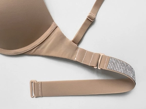 Macro view of crystal rhinestones and strap connection on the seamless push-up bra
