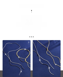 Detailed close-up of flexible gold and silver snake bone chain necklaces on velvet