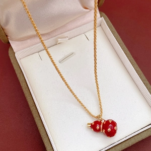 Detail view of 18k gold plated gourd pendant necklace inside a luxury jewelry gift box