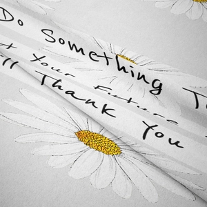 Detail of bohemian tapestry fabric with daisy prints and motivational quote text