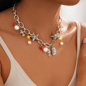 Close-up of vintage silver necklace with pearls, cross, star and cowboy hat charms on model
