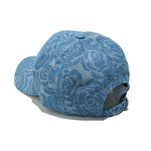 Close-up of blue denim baseball cap with rose jacquard and adjustable metal buckle