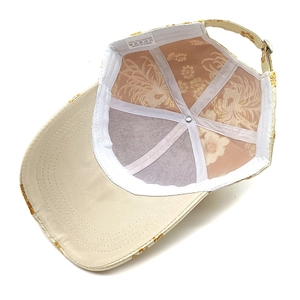 Detail of floral jacquard baseball cap lining and 100% polyester washing label