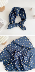 Detail of navy blue floral silk scarf showing soft drape and bow knot styling