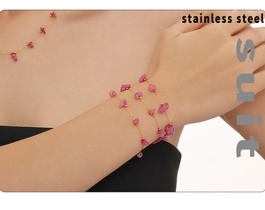 Detail of pink natural stone necklace and bracelet set on model in stainless steel