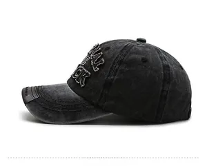 Detailed side view of washed dark grey denim baseball cap with 3D letter embroidery