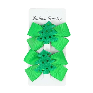 Detail of green Christmas tree bow hair clips for girls featuring sequins and beadwork