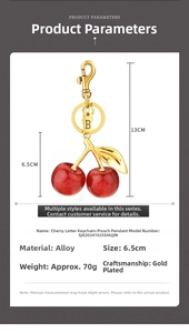Detailed size view of red glitter cherry keychain with letter B tag and gold hardware