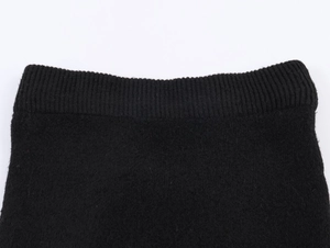Close-up of the black knitted waist detail showing tight stitching on the Christmas set