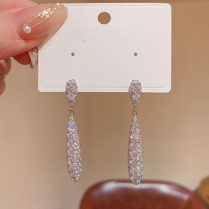 Detailed view of silver teardrop earrings featuring sparkling rhinestones and S925 posts