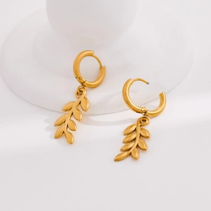 Minimalist gold wheat ear hoop earrings with leaf dangles on a white display stand