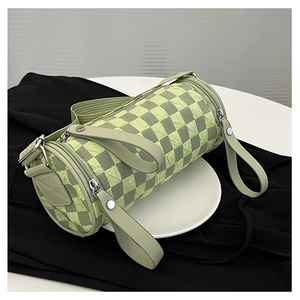 Detail of checkerboard cylinder bag showing green and gray pleated fabric texture