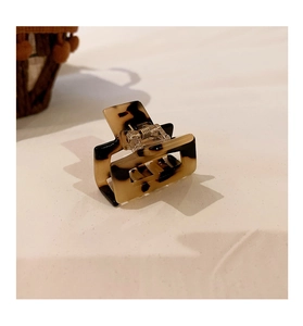 Detail of tortoise shell square hollow hair claw clip with strong metal spring