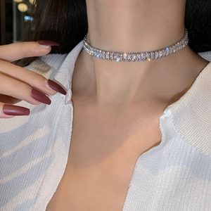 Close-up of sparkling silver choker necklace featuring rectangle cubic zirconia stones