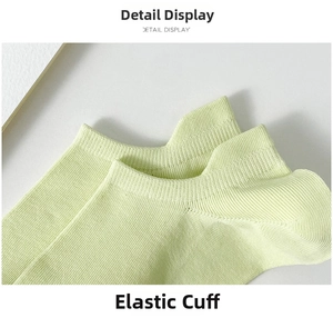 Close-up of elastic ribbed cuff on light green cotton ankle socks with fine knitting texture