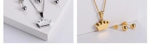 Macro detail of crown pendants and ball earrings set in polished gold and silver finishes