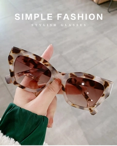 Detail showing creamy tortoiseshell texture and brown gradient lenses on cat eye sunglasses