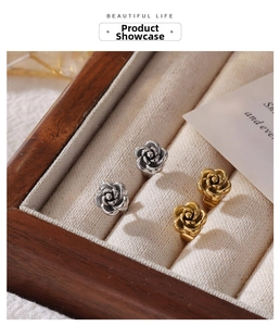 Detailed close-up of vintage flower earrings in gold and silver finish in a jewelry box