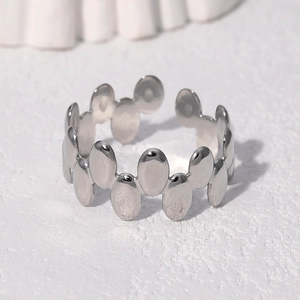 Macro shot of silver adjustable open ring featuring vertical oval dot pattern details