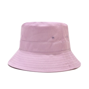 Close-up of purple canvas bucket hat fabric showing fine stitching and eyelet details