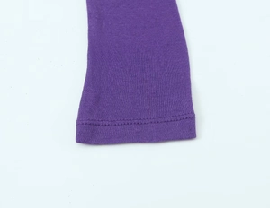 Detailed close-up of purple knit sweater cuff with high-quality double-needle stitching