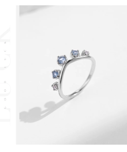 Close-up of S925 silver wave ring featuring alternating blue and pink zircon gemstones
