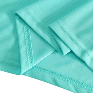 Macro shot of mint green pique knit polo shirt hem with precision double-needle stitching