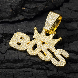 Golden BOSS crown pendant with full rhinestones on Cuban link chain against black background