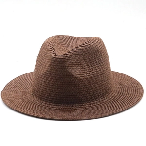 Detail of dark brown fedora straw hat showing intricate woven texture and classic pinched crown