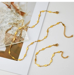 Detail of gold-plated tennis racket textured oval chain necklace and bracelet set