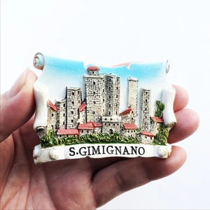 Close-up of 3D resin San Gimignano souvenir fridge magnet held by hand for display