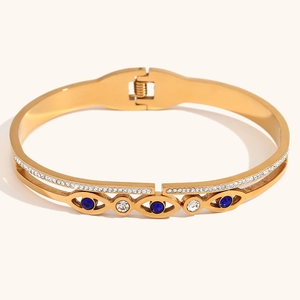 Detailed macro view of the gold stainless steel Evil Eye bracelet with blue crystal inlay