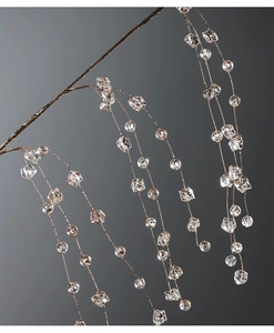 Detailed macro view of clear acrylic beaded icicle ornaments with unique black speckle texture